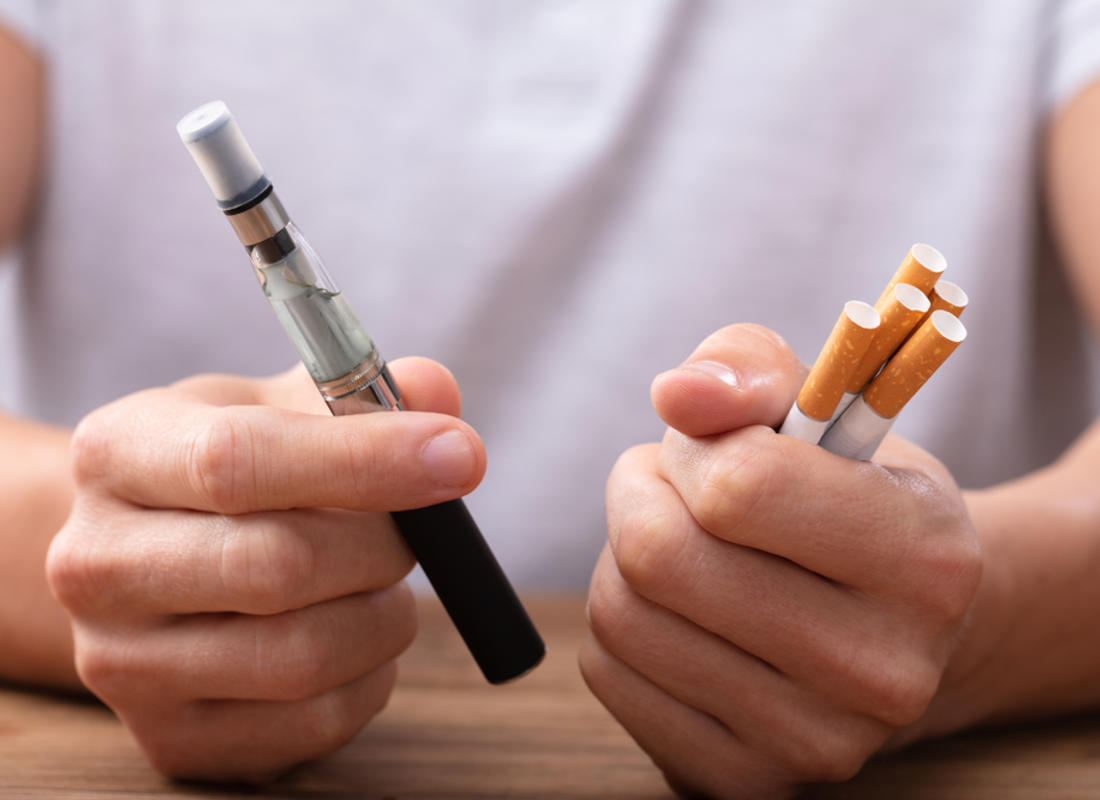 stop smoking scheme man holds vape and ciggies in hands