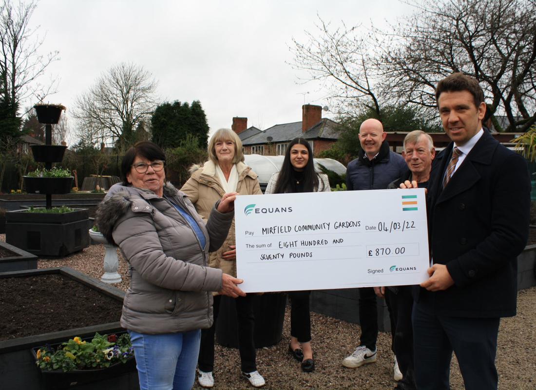 Marina And The Team From Mirfield Community Gardens Receiving A Cheque From The Equans Team