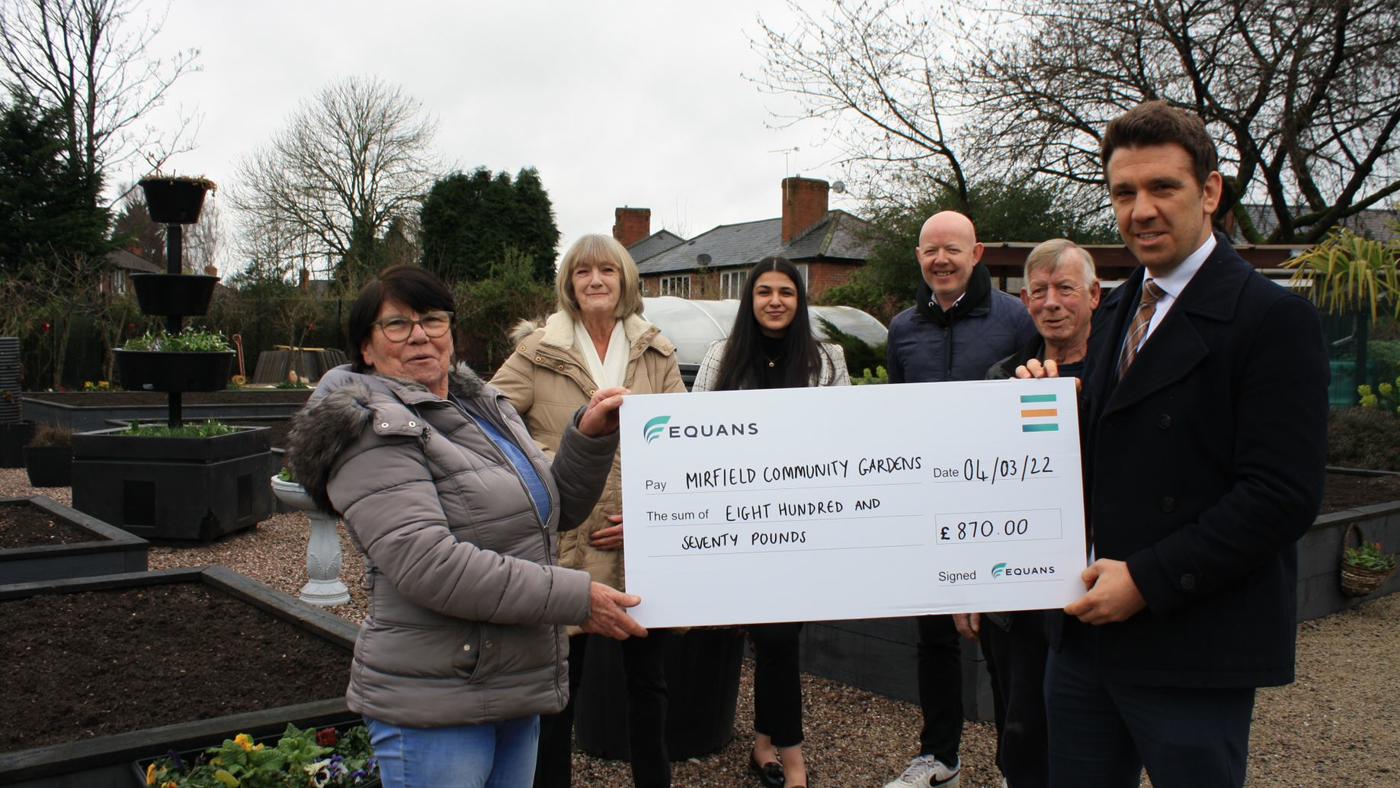 Marina And The Team From Mirfield Community Gardens Receiving A Cheque From The Equans Team