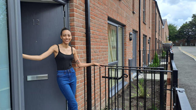 A tenant standing outside their home