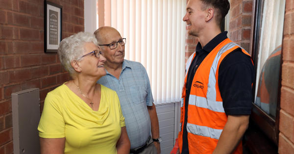 an elderly couple talking to a young engie engineer