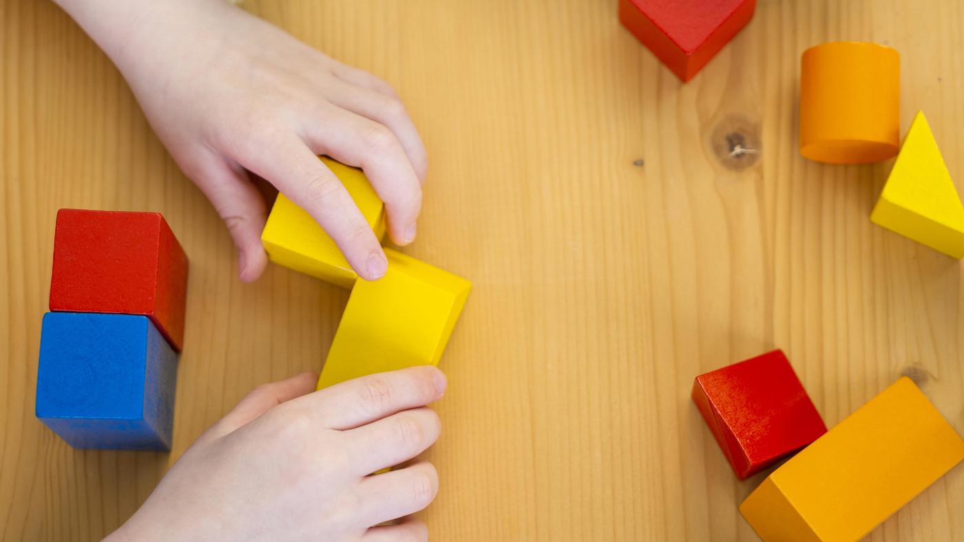 Little Boy Playing With Colorful Shapes Game