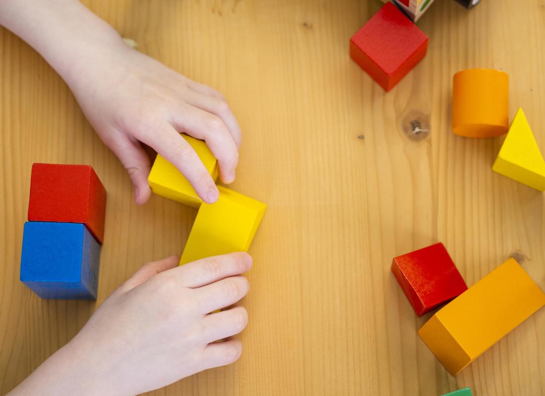 Little Boy Playing With Colorful Shapes Game