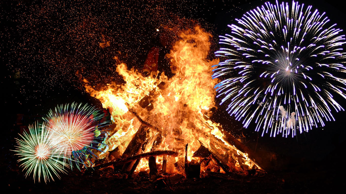 bonfire flocked with exploding fireworks