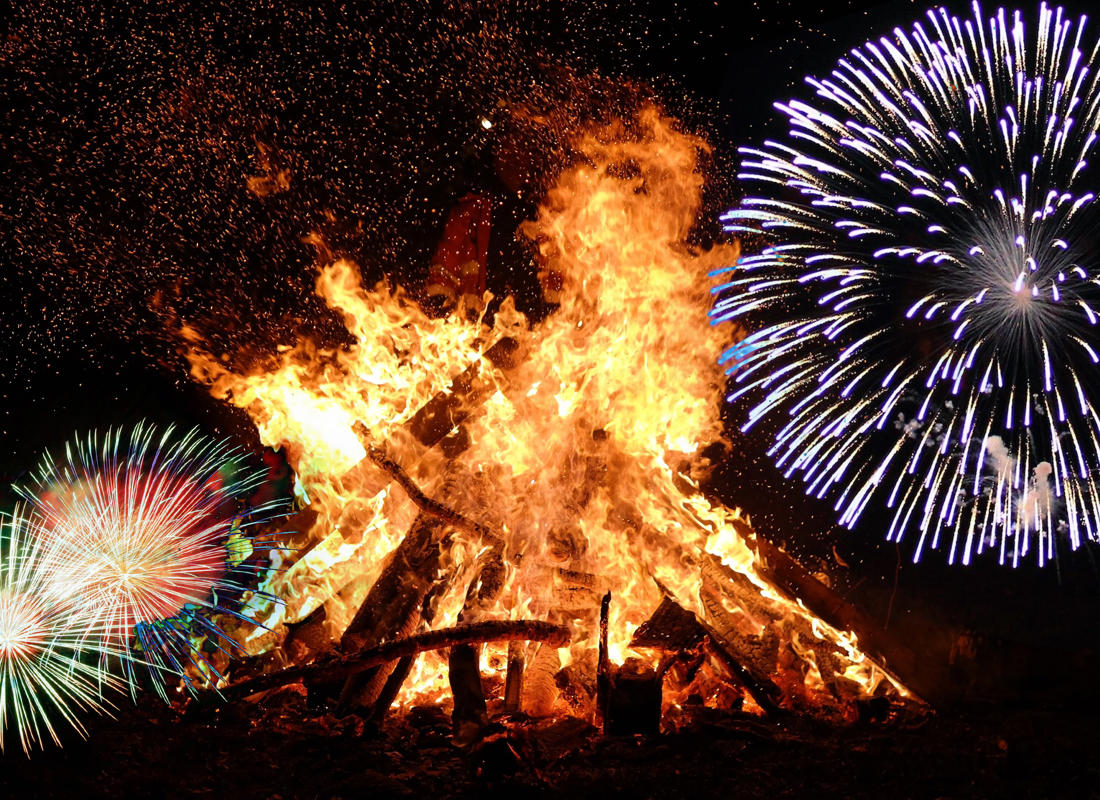 bonfire flocked with exploding fireworks