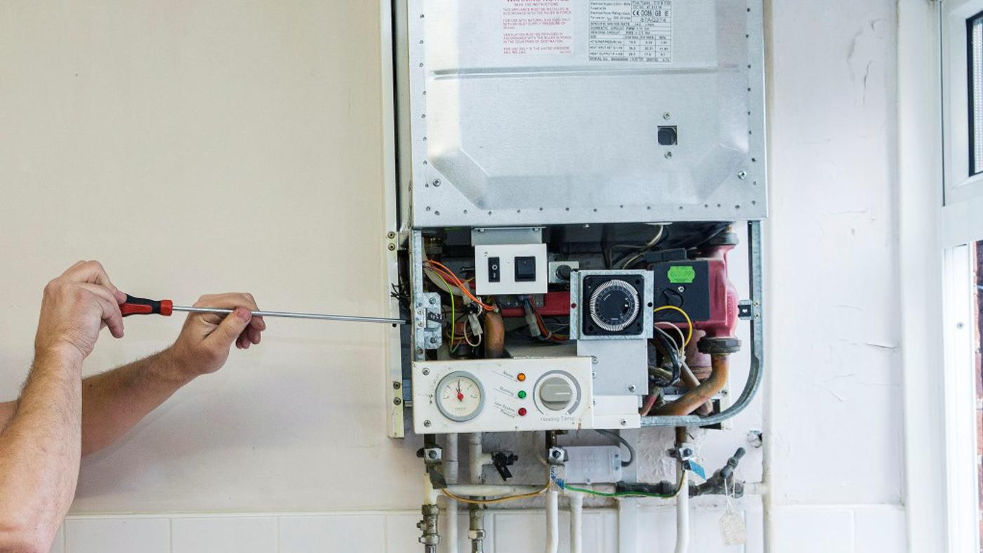 An Image Of Someone Carrying Out A Repair To A Boiler