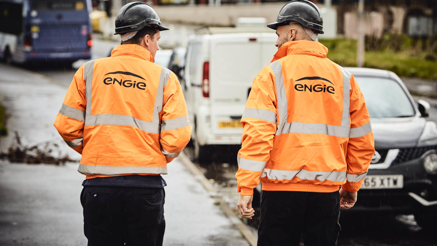 two members of engie staff walking down the street with their protective gear on