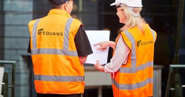 A Photo Of two Equans Staff with hi-viz jackets on