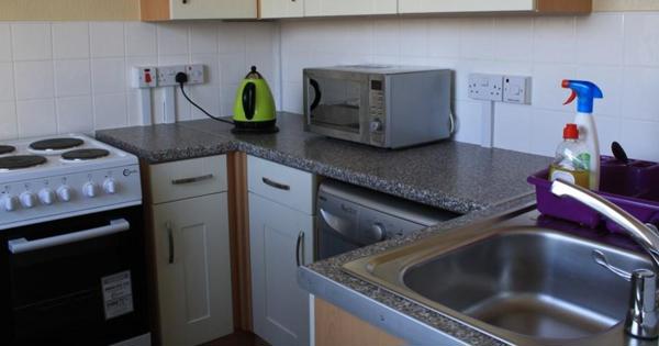 a new kitchen with cooker, microwave, sink and fixtures and fittings